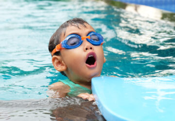 asian cute boy enjoy swimming in pool