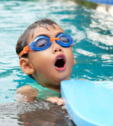 asian cute boy enjoy swimming in pool