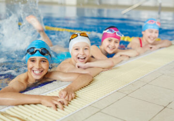 Happy group of children swimming together