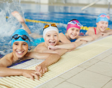 Happy group of children swimming together